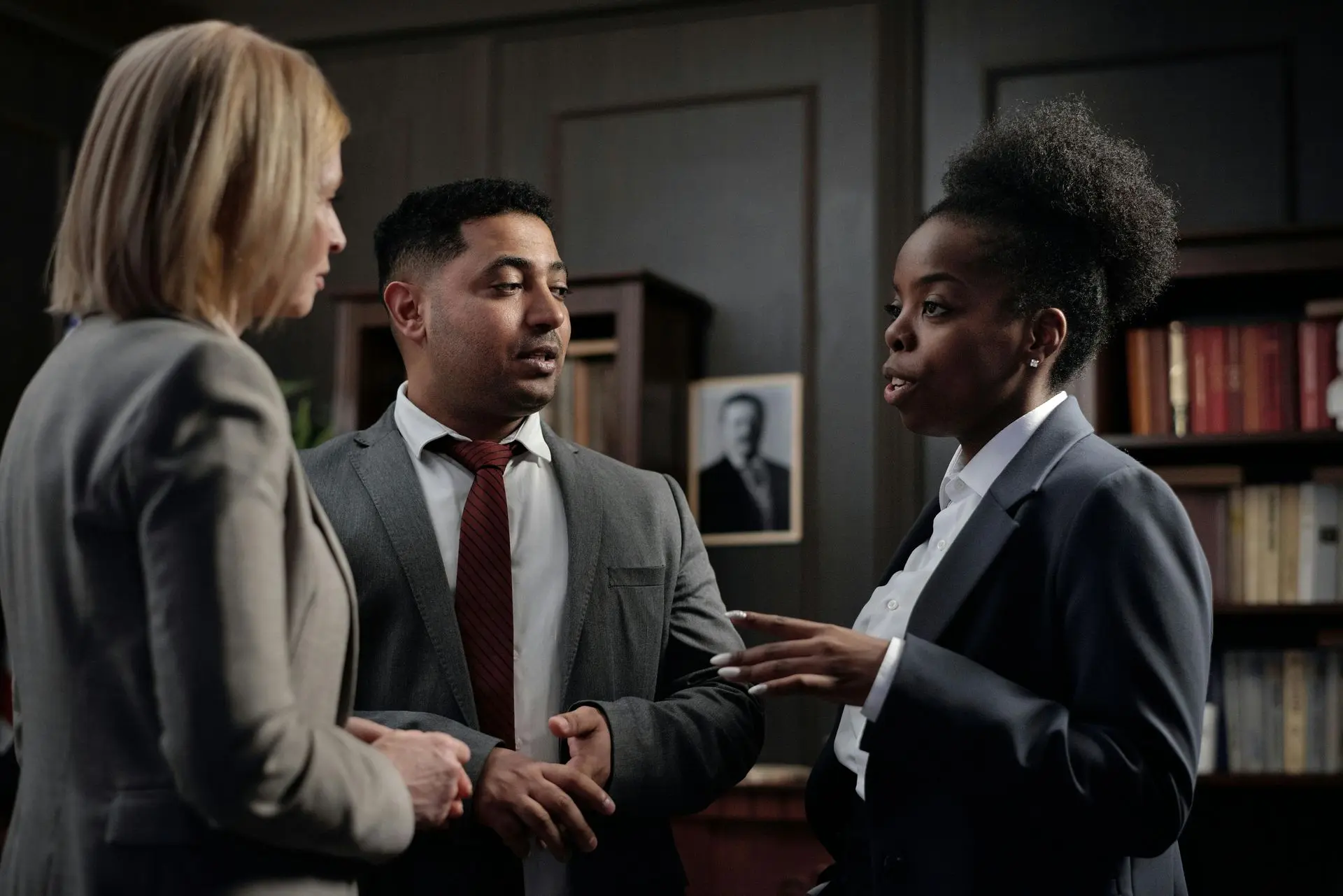 Three legal professionals in conversation