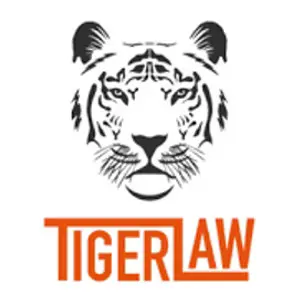 Stylised black-and-white tiger face above the words “Tiger Law” in bold orange lettering.